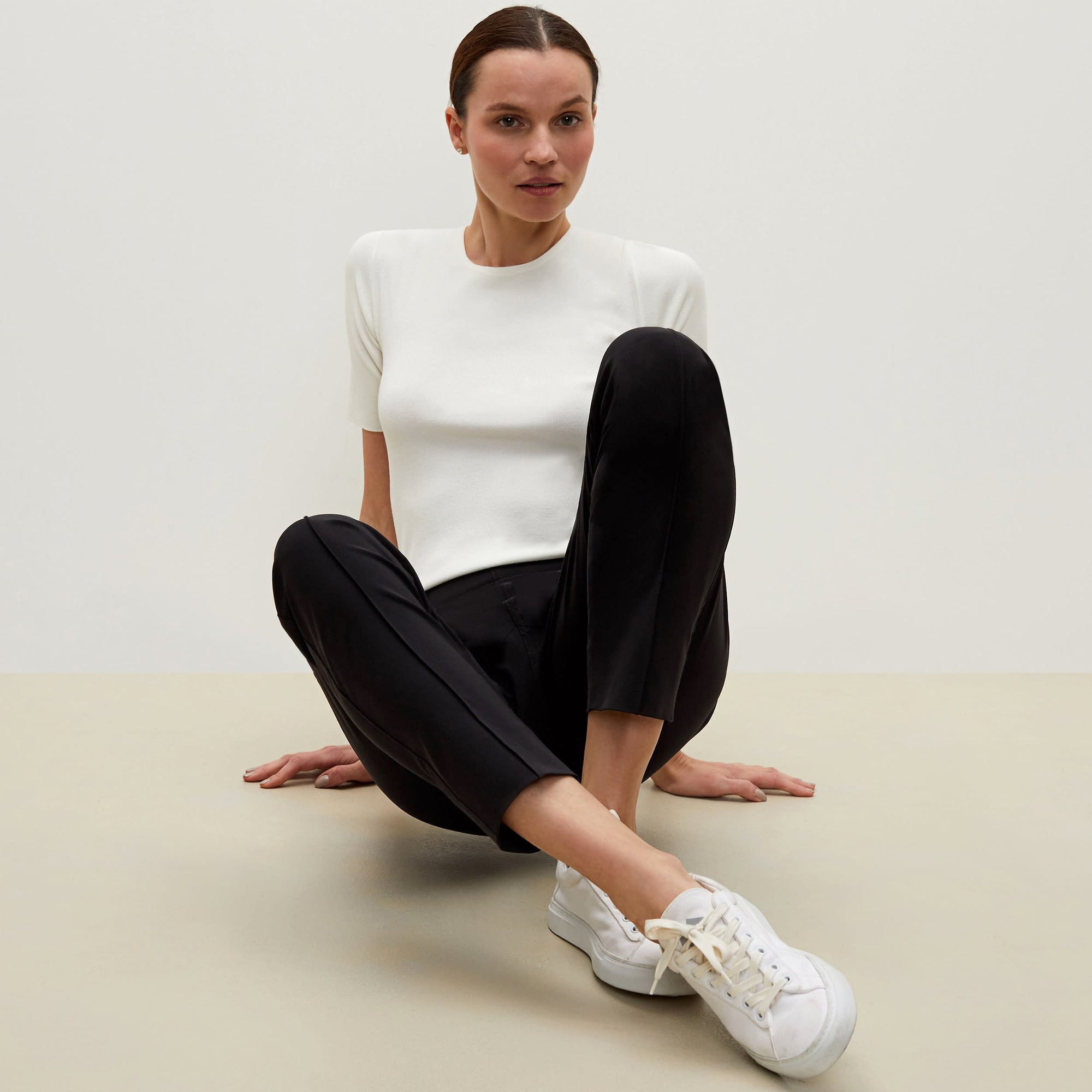 Front image of a woman sitting wearing the Colby Jogger in Black | Exclude