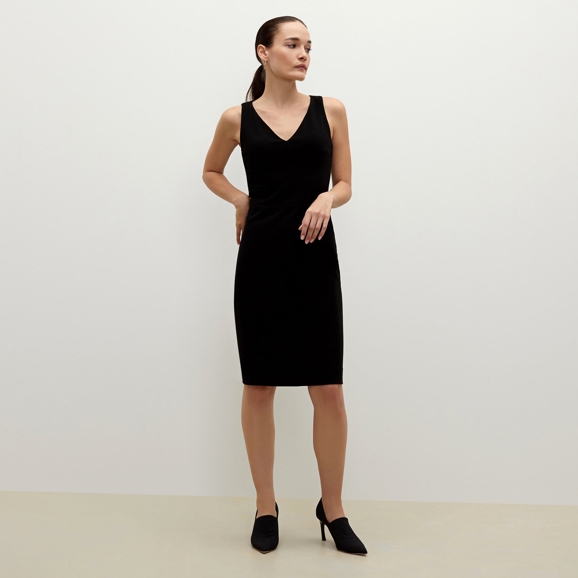 Front image of a woman standing wearing the Rachel dress in black | Lead