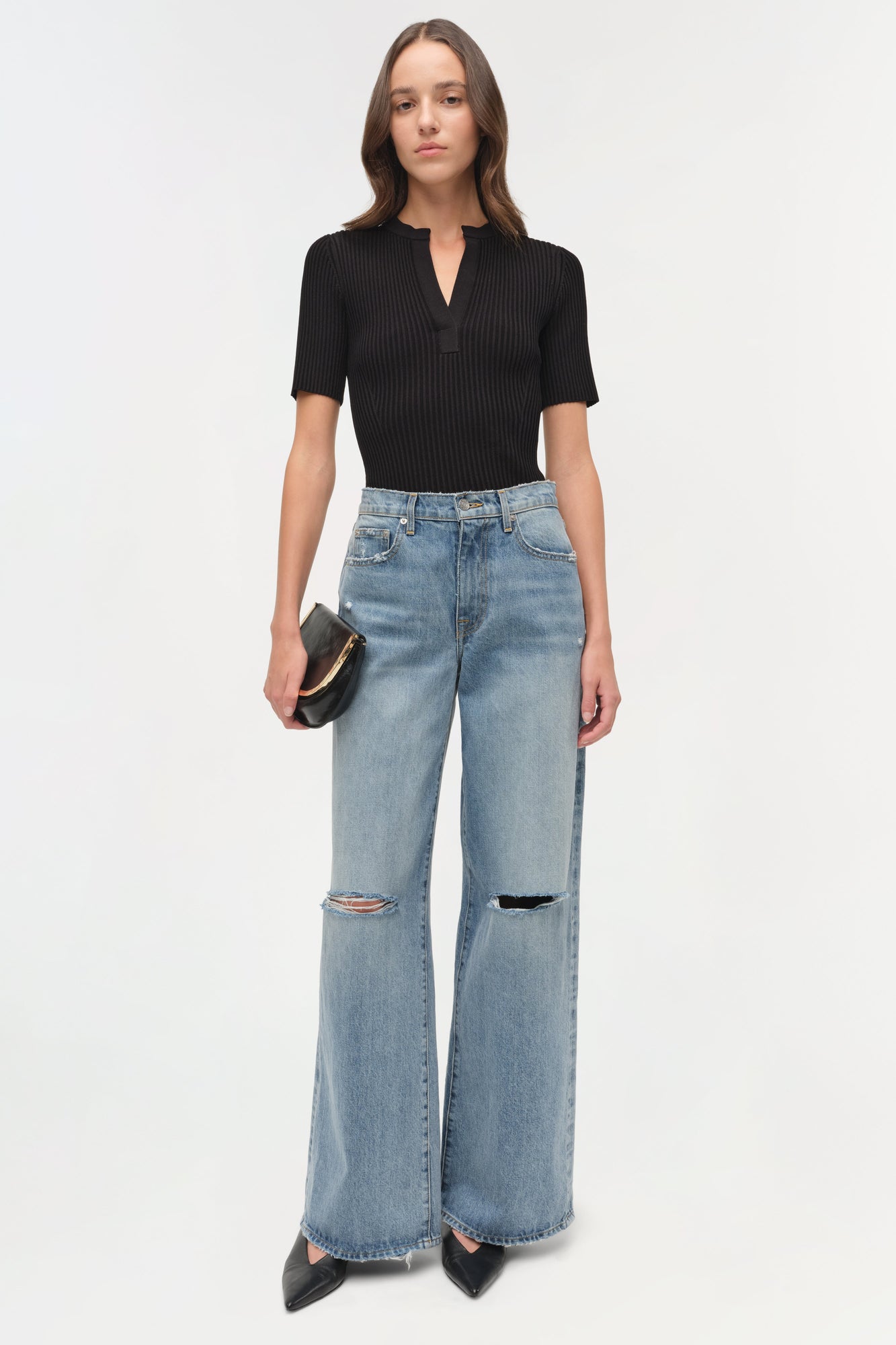 Light blue denim straight crop pants with ripped knees and distressed hem, styled with black ribbed top.