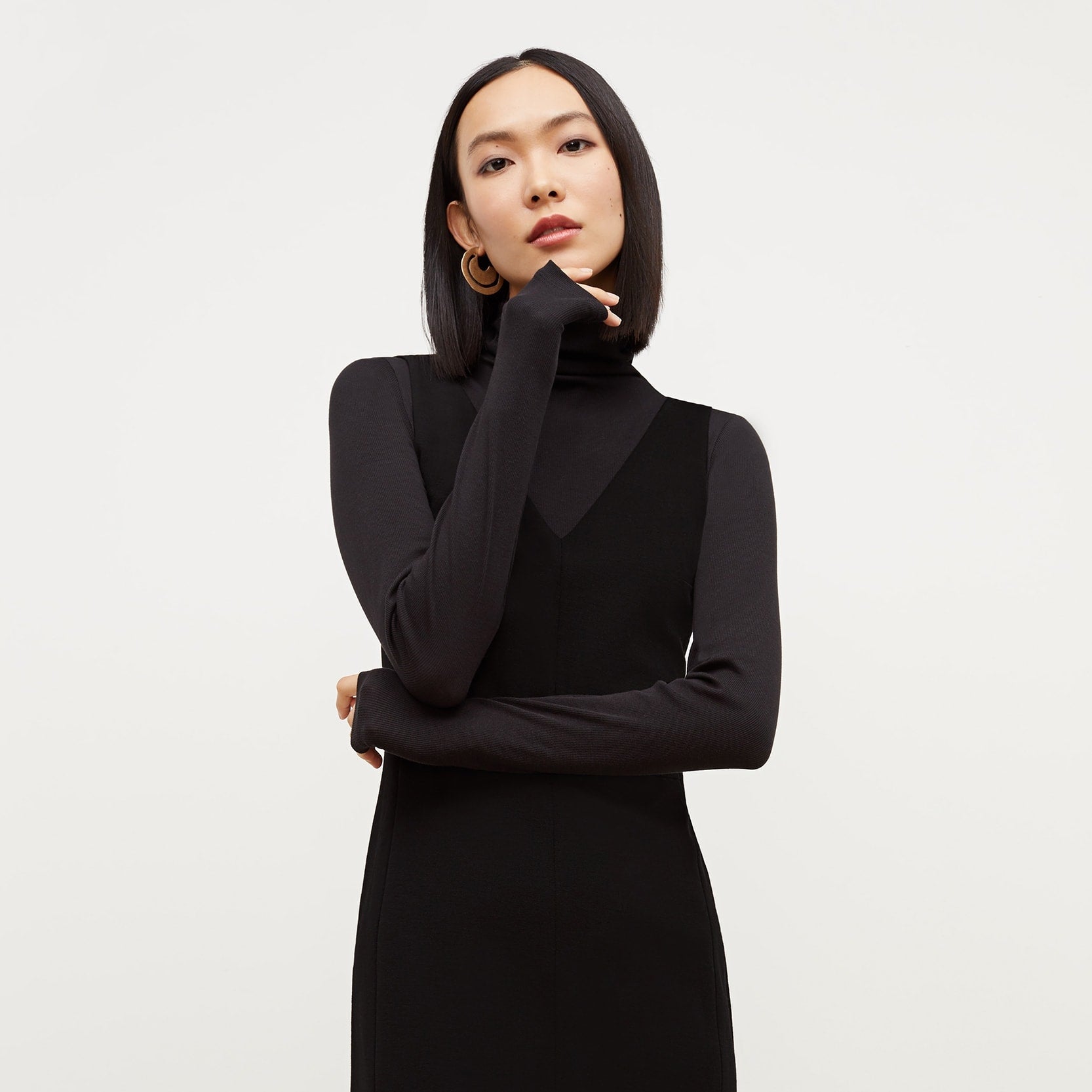 Front image of a woman standing wearing the Rachel dress in black | Exclude