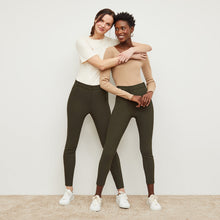 Front image of a woman standing wearing the curie pant in dark olive | Lead