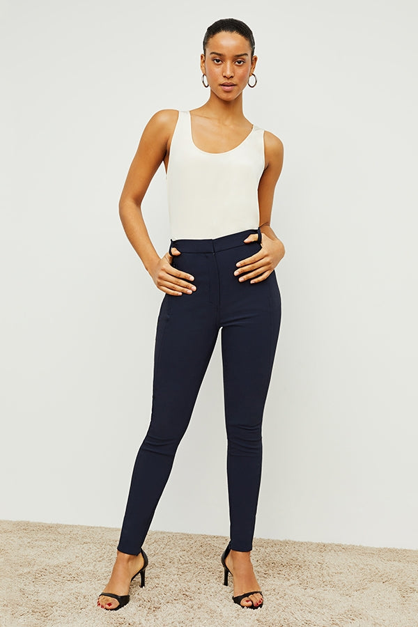Front image of a woman standing wearing the curie pant in dark navy | Exclude | Grid