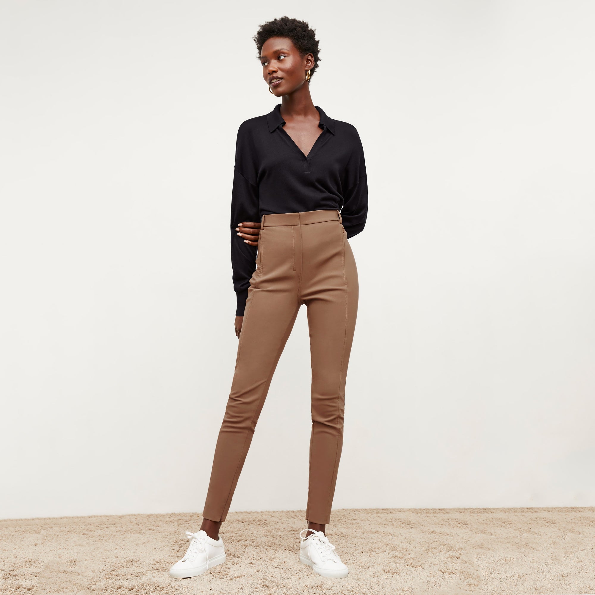 Front image of a woman standing wearing the Curie Pant—Everstretch in Saddle | Exclude