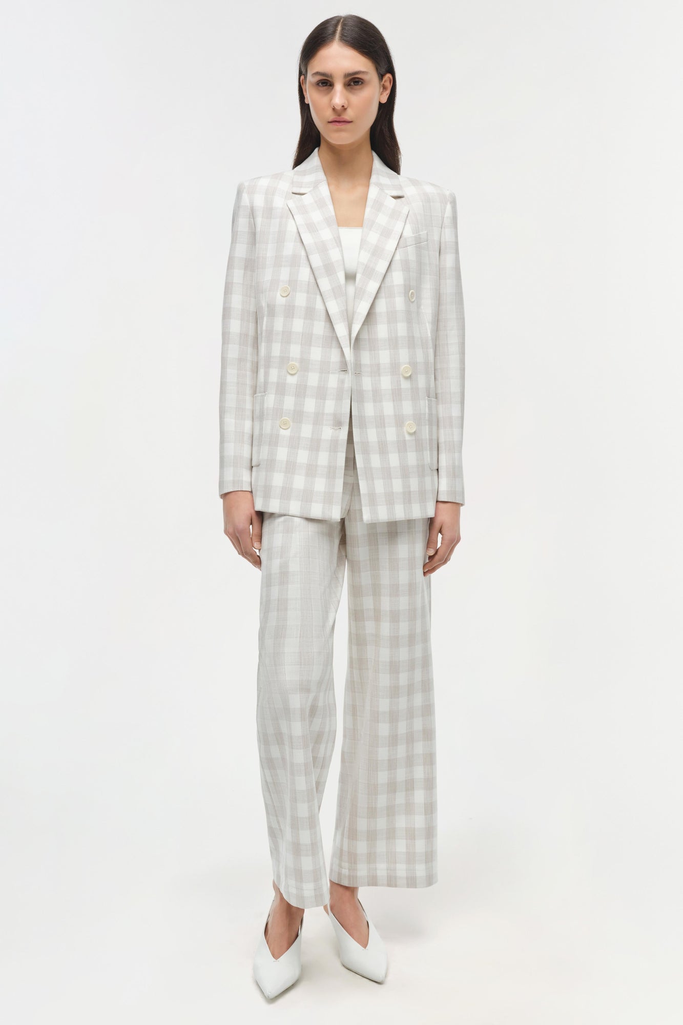 Cream and beige gingham double-breasted blazer with matching wide-leg trousers and white boots.