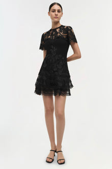 Black lace dress with short sleeves, tiered lace ruffle skirt, and crew neckline.
