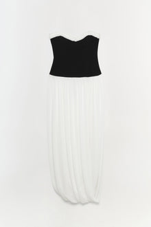 Strapless dress with black bustier top, white lace neckline trim, and ivory pleated skirt.