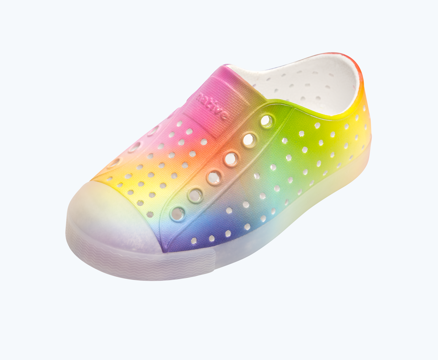 Angled view of a Native Shoes Kids Jefferson Print Kids | Shell White/ Translucent/ Rainbow Blur Footwear