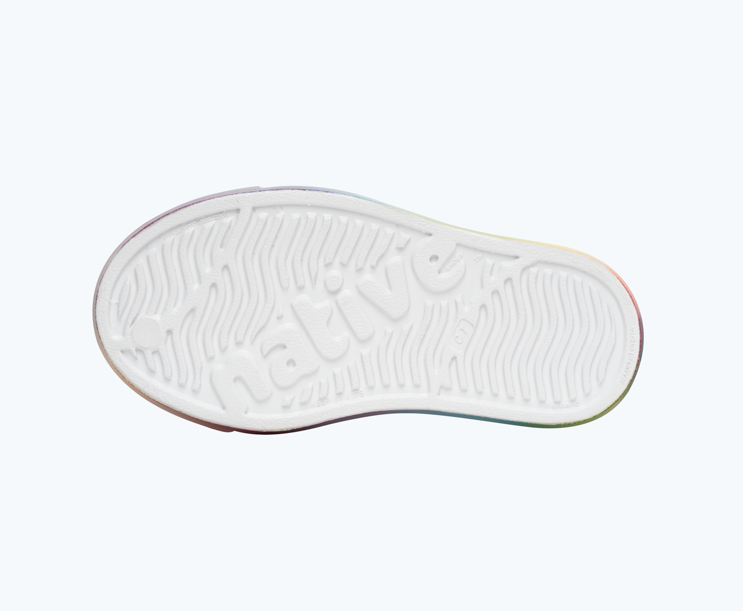 Bottom view of a Native Shoes Kids Jefferson Print Kids | Shell White/ Translucent/ Rainbow Blur Footwear