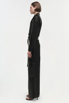 Black leather jacket with long sleeves, collar, and zip front, shown on model in side profile.