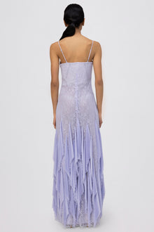 Lavender lace gown with spaghetti straps, fitted bodice, and pleated handkerchief hem skirt, shown from back view.