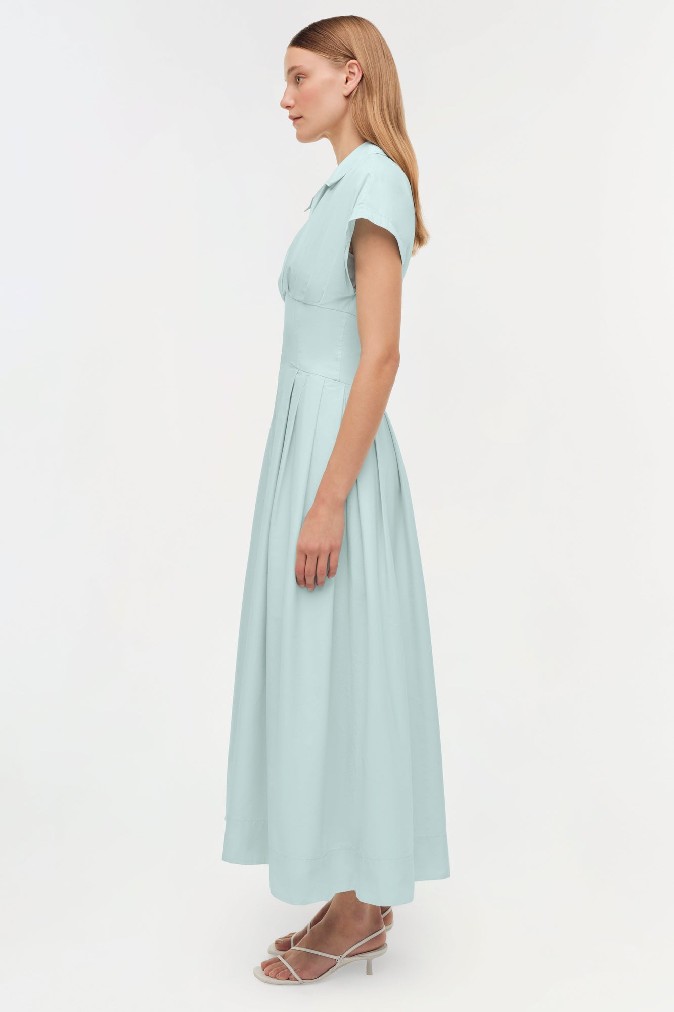 Light blue cotton faille midi dress with short sleeves and pleated skirt, shown on model from side view.