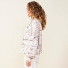 Side view of model wearing the space dye sweater cardigan in fruity pebbles.