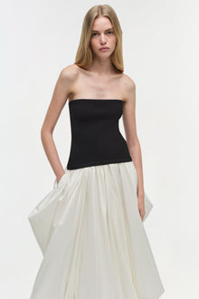 Strapless midi dress with black fitted bodice and cream pleated skirt with side pockets.