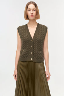 Olive green sleeveless cashmere vest with cable knit pattern, button front, and patch pockets.