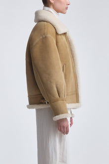 Model is Wearing the Nour Hammour Portia Modern Shearling Aviator Jacket Biscuit - Side