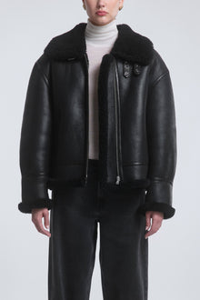 Model is Wearing the Nour Hammour Portia Modern Shearling Aviator Jacket Black - Front Open