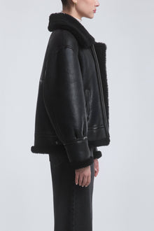 Model is Wearing the Nour Hammour Portia Modern Shearling Aviator Jacket Black - Side