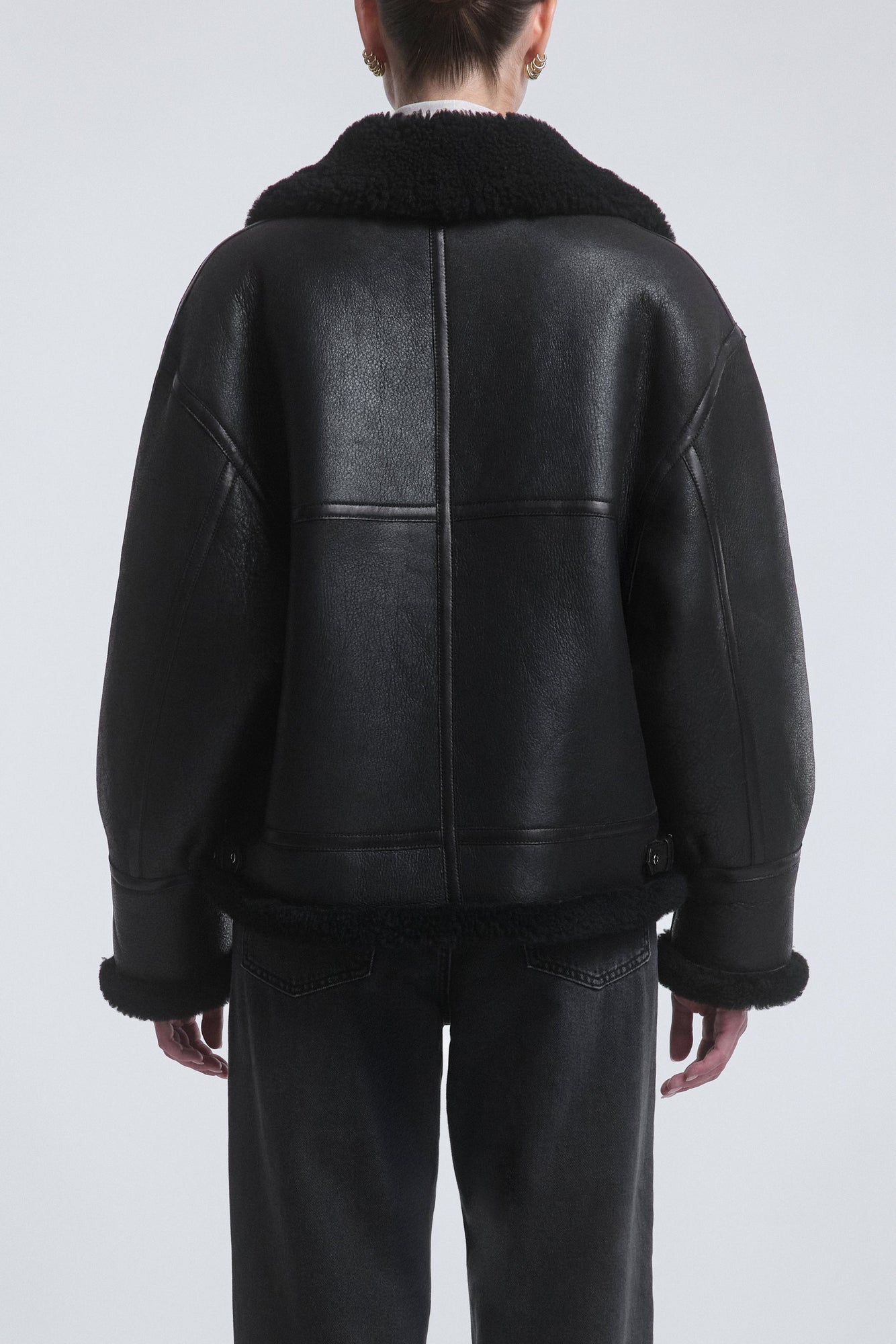 Model is Wearing the Nour Hammour Portia Modern Shearling Aviator Jacket Black - Back