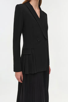Black double-breasted blazer dress with pleated skirt detail and long sleeves.
