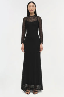 Black lace long-sleeved gown with sheer lace panels and fitted silhouette on model.
