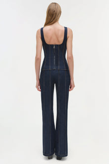 Dark blue denim bustier top with structured boning and wide-leg pants, shown from back view with open back design.