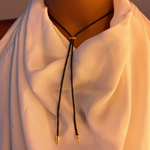 backside of the Keishi Pearl with Nylon Cord, styled on a neck