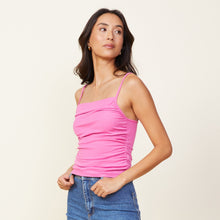 Side view of model wearing the rib shirred tank in raspberry rose.