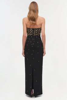 Black strapless gown with gold beaded bodice and scattered gold crescent moon details on skirt, rear view.