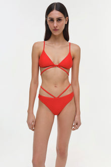 Red bikini top with thin spaghetti straps and cutout detail at center front.