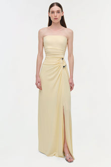 Cream strapless floor-length gown with draped bodice, ruched waist detail, and side slit.