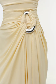 Cream-colored gown with draped jersey fabric, cinched waist with silver metal ring detail and tied knot accent.