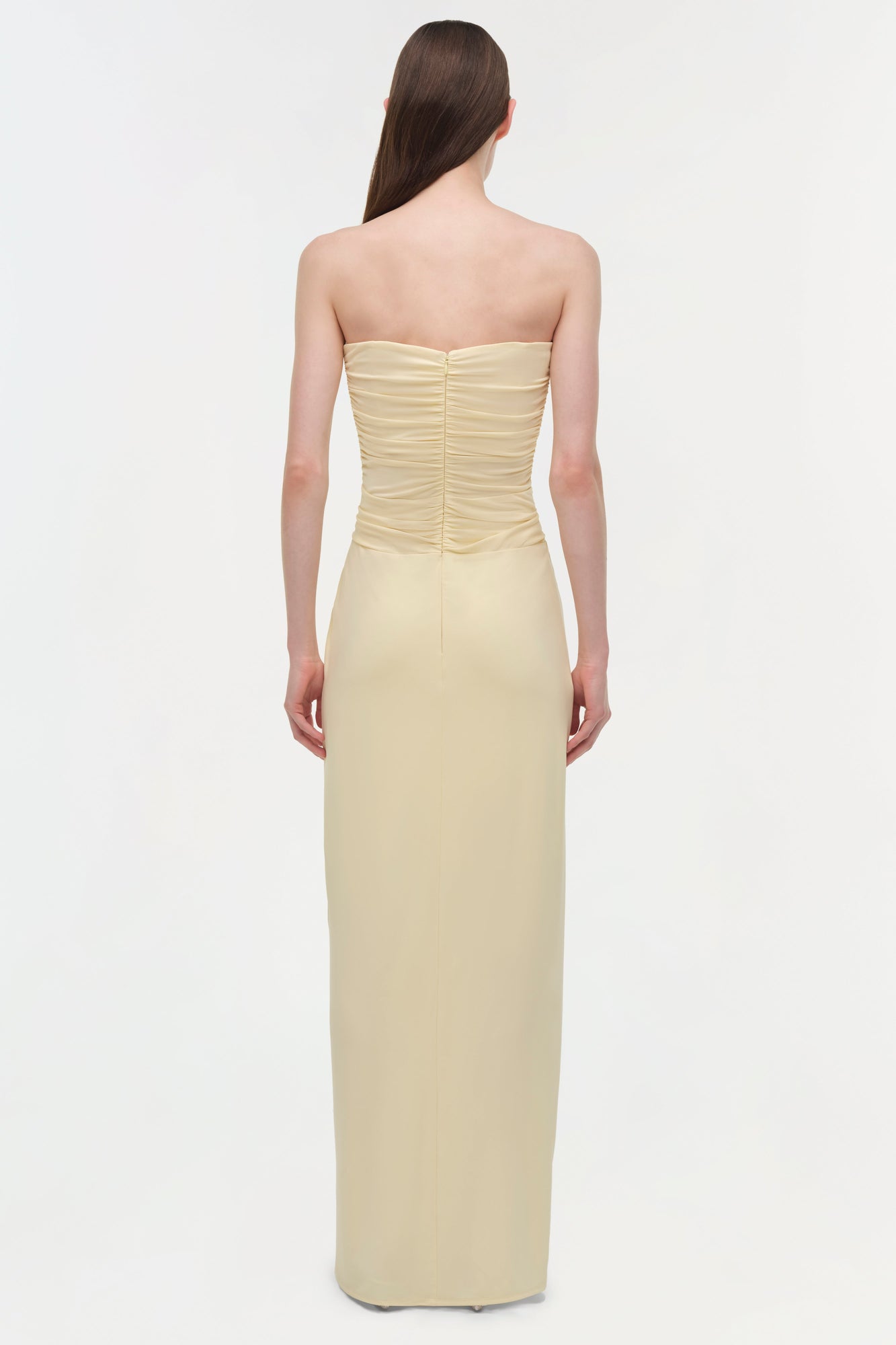 Cream strapless gown with ruched bustier bodice and floor-length skirt, shown from back view.