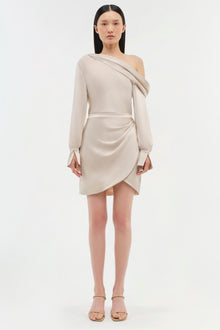 Beige off-shoulder dress with long sleeves, draped neckline, and asymmetrical wrap skirt detail.