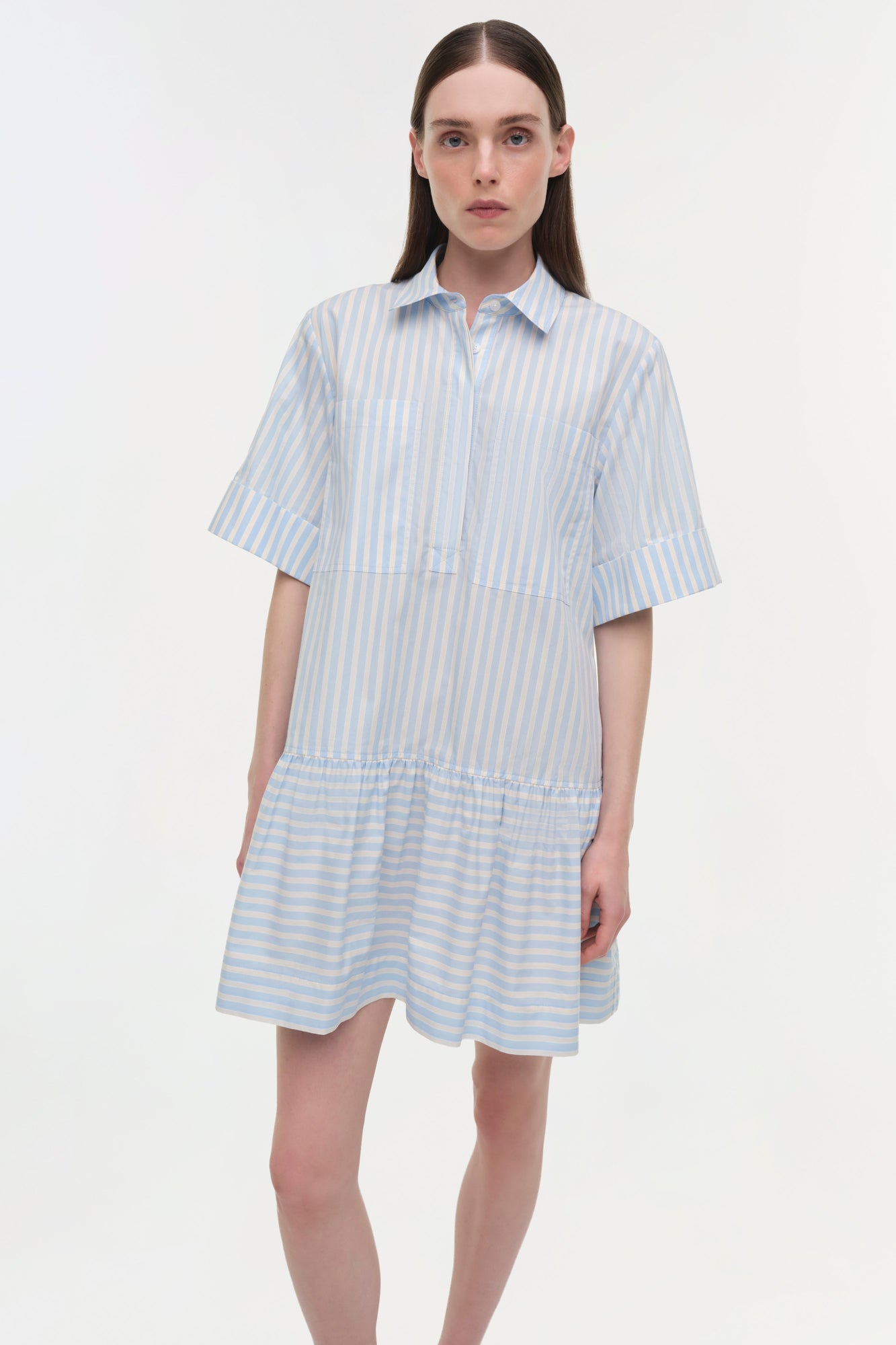 Blue and white striped cotton shirt dress with short sleeves and gathered skirt hem.