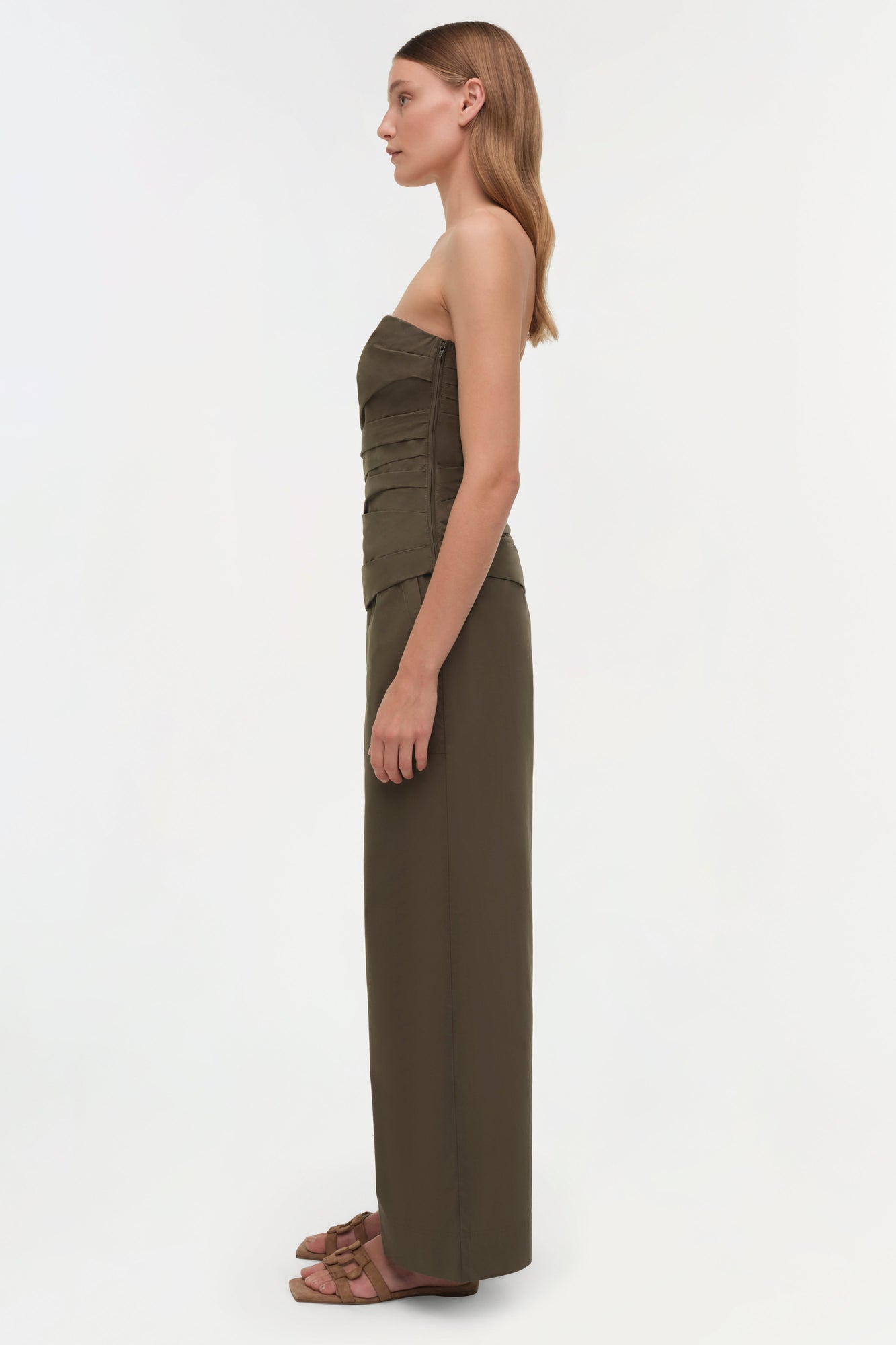 Olive green strapless bustier top with ruched detailing on the front, paired with matching wide-leg trousers.