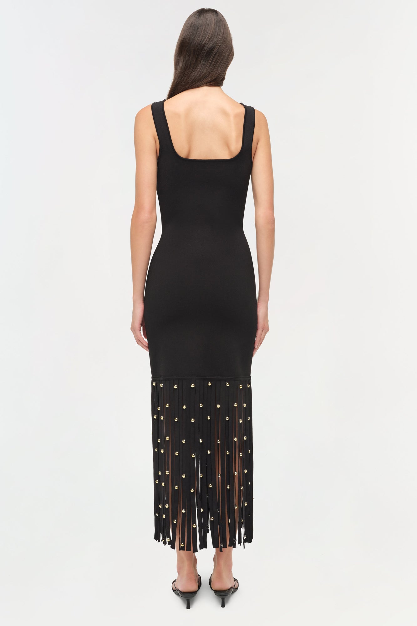 Black knit midi dress with square neckline and beaded fringe hem at bottom.