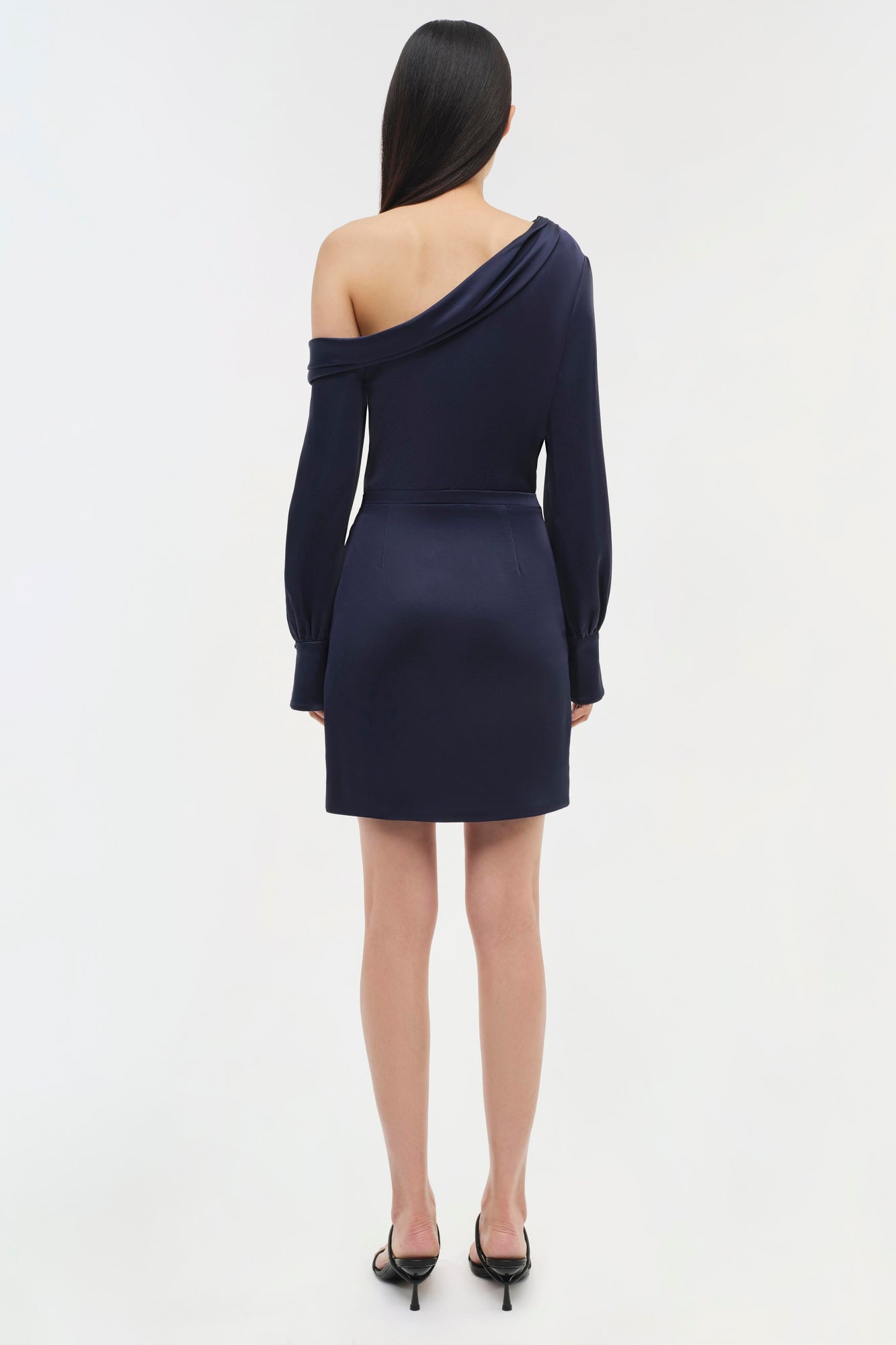 Navy off-shoulder dress with long puffed sleeves and knee-length skirt, shown from back view.