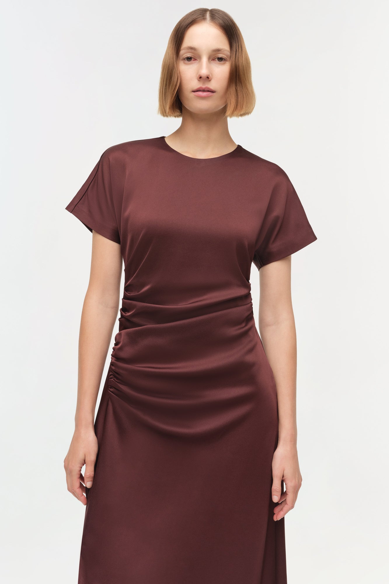 Burgundy satin midi dress with short sleeves, crew neckline, and ruched detailing on the side.