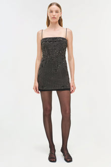 Black mini dress with silver beaded embellishments, thin straps, and straight neckline.