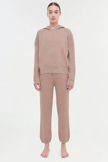 Beige cable knit hoodie and matching jogger pants on model shown front view.