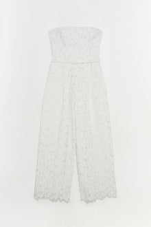 White lace strapless jumpsuit with a belted waist and wide-leg cropped pants with scalloped hem.