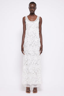 White sleeveless maxi dress with textured fringe pattern and scoop neckline.