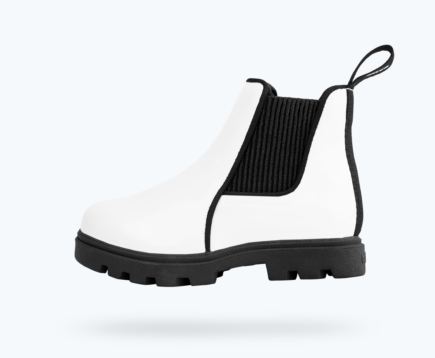 Side view of a Native Shoes Kids Kensington Treklite Gloss Kids | Shell White Gloss/ Jiffy Black Footwear