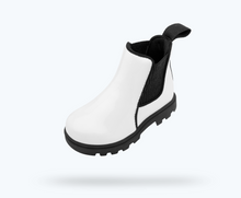 Angled view of a Native Shoes Kids Kensington Treklite Gloss Kids | Shell White Gloss/ Jiffy Black Footwear