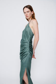 Sage green halter gown with ruched side detailing and front slit.