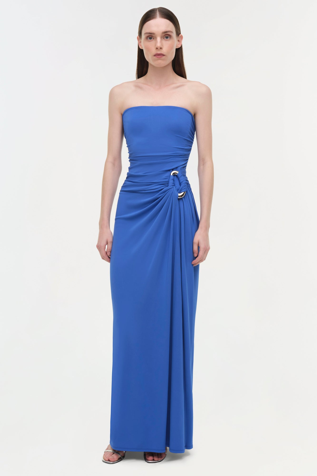 Royal blue strapless gown with ruched side draping and gold buckle detail at waist.