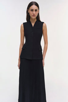 Black sleeveless vest dress with button front and pleated maxi skirt.