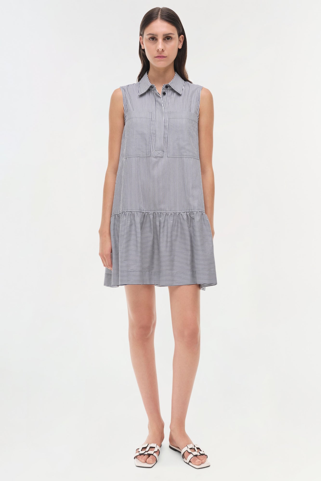 Sleeveless shirt dress with vertical stripes on top and horizontal stripes on bottom, featuring a collar and button front.