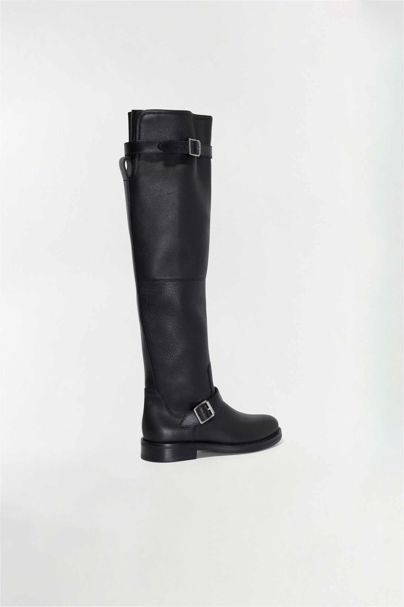 Black leather over-the-knee boot with buckle straps and flat sole, shown in side profile.