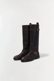 Black leather motorcycle boots with buckle straps and distressed finish, shown from the front.
